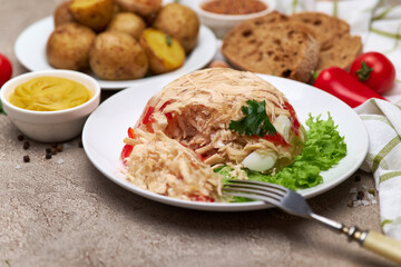 Delicious chicken aspic on a plate on concrete table