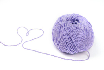 Woolen yarn isolated on white background in the form of a violet heart valentine's day