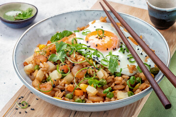 Shrimp fried rice with vegetables and fried egg