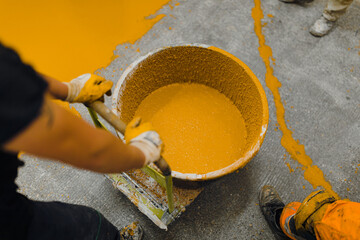 epoxy flooring applicator performs painting works with polyurethane epoxy mortar