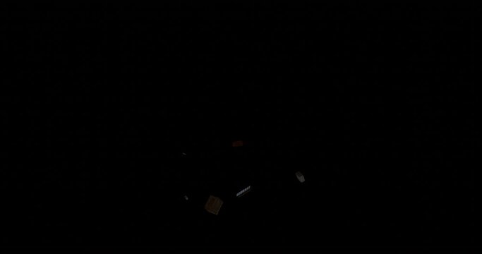 flying parts of building bricks, simulation of the explosion of falling bricks on a black background