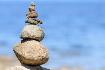 Fototapeta na wymiar Sea pebbles or stones tower on a beach