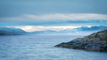 Fototapeta na wymiar Long exposure illustrating the sunrise from a norway peninsula (Lofoten)
