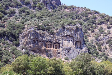 Fototapeta na wymiar Koycegiz, Mugla, Turkey - July 12 2017: The rock tombs of the kings in the ancient city of Kaunos in Koycegiz Dalyan