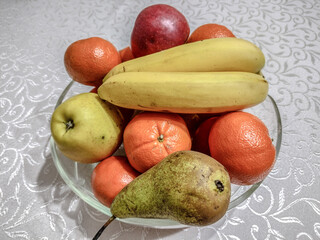 fruits in a bowl - bananas, pears, apples, clementines