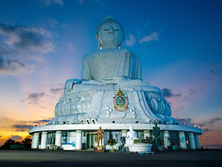 Fototapeta premium Big Buddha statue Was built on high hilltop of Phuket Thailand. Can be seen from distance, Big Buddha is one of Phuket island most important and revered landmarks against the sunset sky. Bottom view
