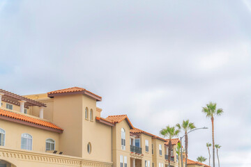 Fototapeta na wymiar Apartment building with clay tiles roofing and balconies at Carlsbad, San Diego, California