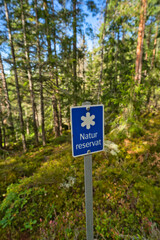 Nature reserve sign in front of forest in sweden