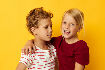 two joyful children standing side by side posing childhood emotions isolated background