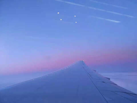 A Beautiful View Of Long Wing Of Plane With Amazing Gradient Purple Sky