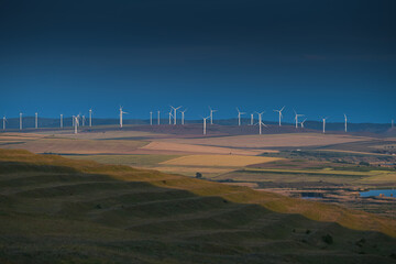 Eolian wind turbines farm in Dobrogea, Romania, during a cloudy morning. Alternative ways for green...