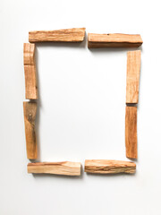 palo santo, incense of the sacred tree, square frame of palo santo sticks, place for text
