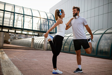 Portrait of happy fit sporty couple exercising and enjoying healthy lifestyle. People sport concept