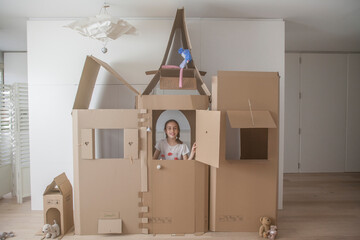 original cardboard house with kid inside