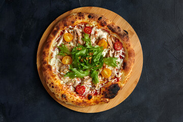 Pizza Caesar. Pizza with chicken, tomato, cheese and lettuce on stone background. Top view. Free space for your text. Delivery food