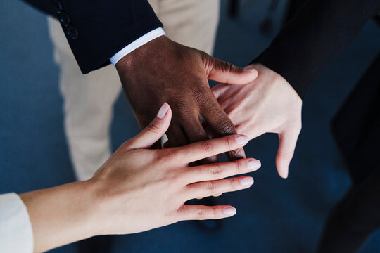 Multi-ethnic business colleagues stacking hands