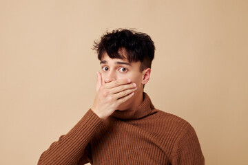 handsome guy stylish hairstyle brown turtleneck light background unaltered