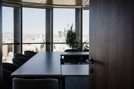 Entrance of empty board room with chairs and tables in office