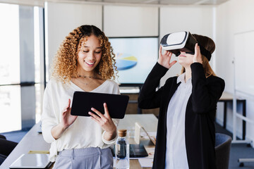 Young business colleagues using wireless technologies in coworking office