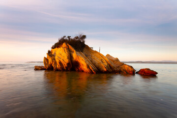 Small rocky outcrop surrounded by water in NSW Australia