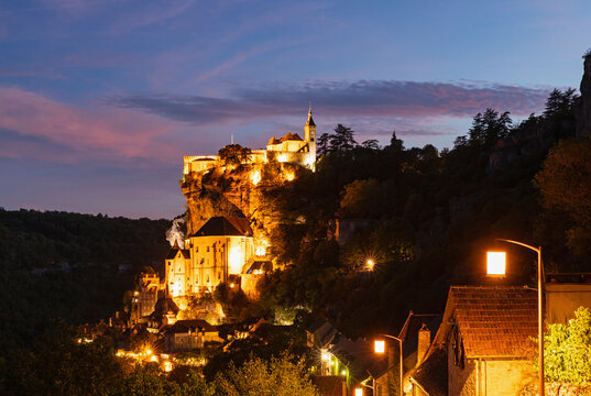 France, Lot, Rocamadour, Illuminated cliffside town at dusk