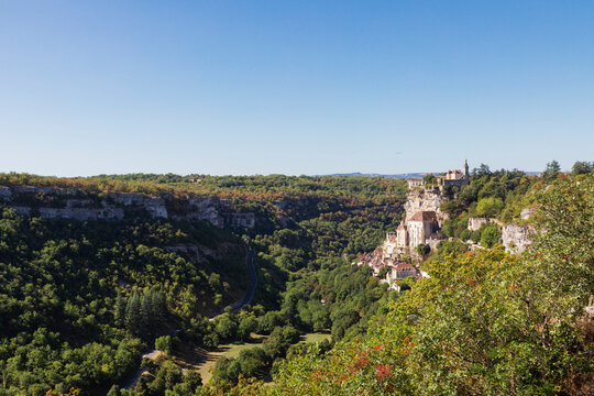 France, Lot, Rocamadour, View of Alzou Canyon in summer with clifside town in background