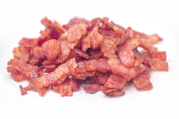 Close up of fried bacon pieces isolated white background.