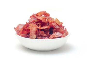 Close up of fried bacon pieces isolated white background.