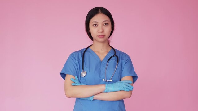 Emergency nurse. Ambulance service. Medical care. Confident serious woman doctor in first aid flashing light isolated on pacific pink background.