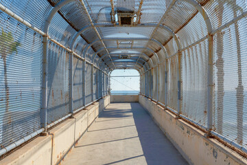 Old covered footbridge with rusty metal roof in San Clemente, California
