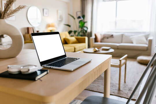 Laptop kept on table in living room