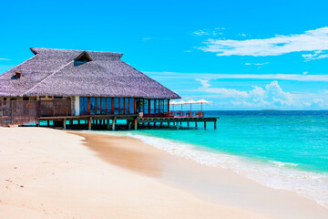 Fototapeta premium picturesque sandy beach in Maldives island near water villa, concept of luxury travel, beautiful exotic tropical landscape