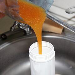 Pouring water softening ion exchange resin to the cartridge closeup after recovery with salt...