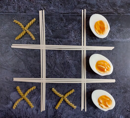 noodles, pasta and eggs on a dark background