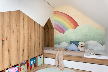 Stylish scandinavian kid room with toys, teddy bear, plush animal toys, furniture, kid accessories. Modern interior with rainbow background walls, Design interior of childroom. Template