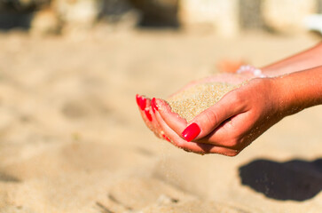 a handful of sand in the hands of a girl