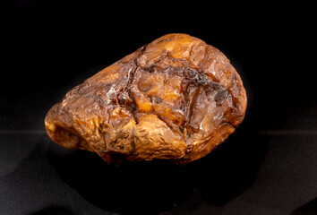 A piece of true amber on a black background