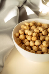 chickpeas in a white bowl on a beige background