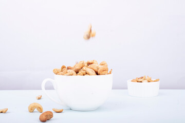 cashew nuts in a white bowl on a light background