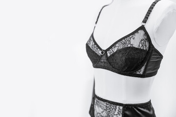 Stylish black lace lingerie underwear on woman mannequin, white background - obrazy, fototapety, plakaty