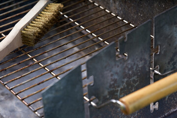 Wooden wire brush for cleaning dirty barbecue grill.