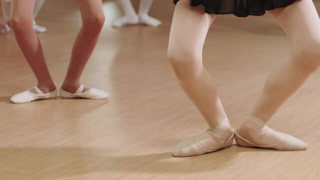 Ballet training - little ballerina girls practising their pointe stands