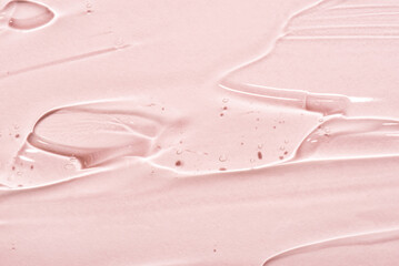 Transparent hyaluronic acid gel on a pink background.