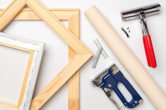 Tools for stretching a canvas with a photo on a wooden stretcher. Top view