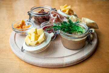 Pork pate with antipasto and sun-dried tomatoes. Original serving pate with appetizers