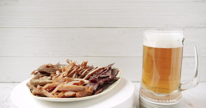Craft Beer into the large glass. Beer Mug. On a white background. Half a liter, close up. Rotation 360 degrees. Glass full of beer with plate minced meat, and snacks. bbq meat set for beer snack. 