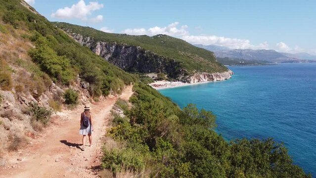 Girl walking to Gjipe Beach and Canyon in Dhermi, Albania - Aerial Drone View