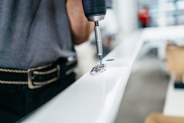 Manual worker assembling PVC doors and windows. Manufacturing jobs. Selective focus. Factory for aluminum and PVC windows and doors production.