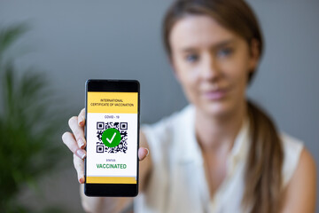 Green pass of the covid-19, a woman shows a mobile phone with the health passport. Vaccination certificate to enter bars and restaurants, coronavirus