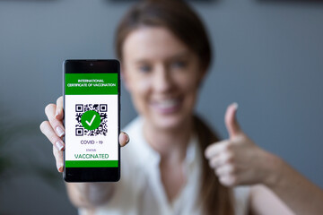 Green pass of the covid-19, a woman shows a mobile phone with the health passport. Vaccination certificate to enter bars and restaurants, coronavirus